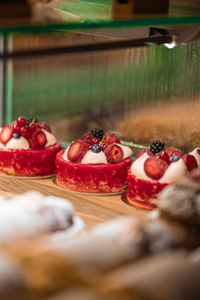 pexels photo 27820705 Tempting berry cakes with cream and strawberries in a bakery display in Istanbul, Türkiye.