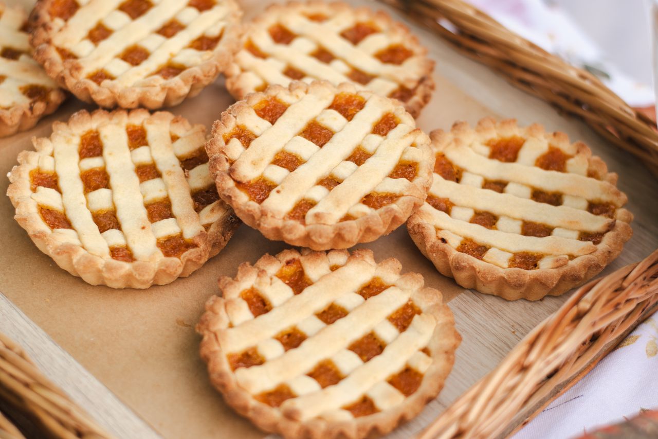 cta-image Assortment of homemade lattice-topped pastries on a tray, perfect for bakery enthusiasts.