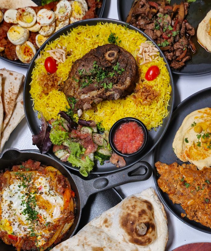 pexels photo 30119029 A delicious spread of Middle Eastern halal dishes including lamb and yellow rice, perfect for a vibrant meal.
